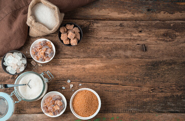 Sugar in a large assortment on a wooden background. Top view with copy space. The concept of food products.
