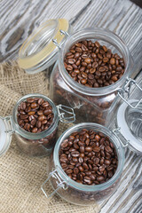 Coffee beans. Poured into cans with a yoke lock. Stand on linen and pine planks. Filmed from above.