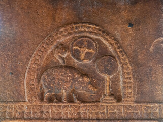 Aihole, Karnataka, India - November 7, 2013: Suryanarayana temple. Brown stone sculpture on wall showing boar and Vishnu symbols,