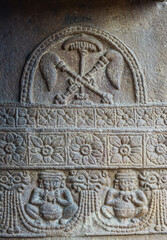 Aihole, Karnataka, India - November 7, 2013: Suryanarayana temple. Gray stone sculpture on wall showing Surya symbols.