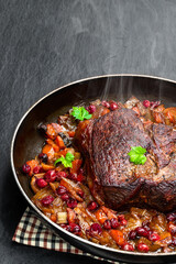 Braised beef with cranberries and vegetables isolated on white