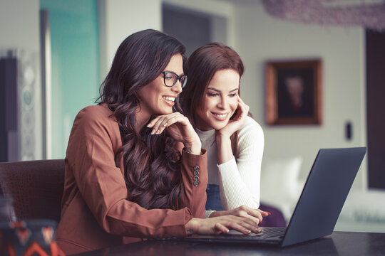 Young caucasian women communicating online on laptop