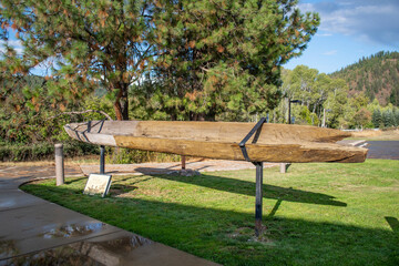 An ancient dug out canoe used by the Coeur d'Alene Tribe of Native Americans on display in the Old Mission State Park in Cataldo, Idaho, USA. - obrazy, fototapety, plakaty