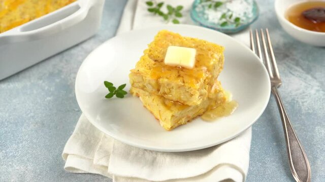 Slices of cheesy cornbread freshly baked served with butter and honey, southern food