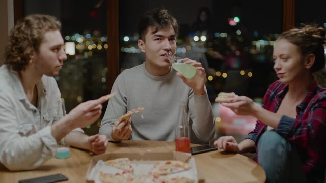 Carefree Friends Eat Pizza and Drink From Bottles