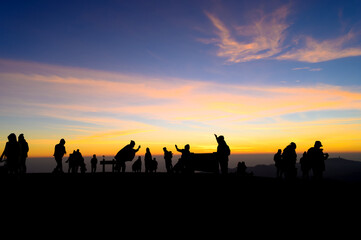 Silhouette group of tourist traveling to see sunrise over phu lom lo mountain