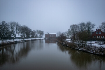 Greetsiel pumping station in the fog in winter