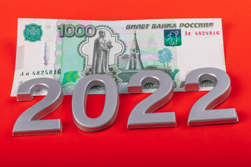 close-up. Black background. on it are numbers 2022 and a bill of 1000 rubles. Russia.
