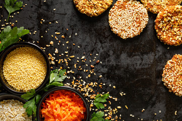 Background with vegetarian cutlets and ingredients to make them on a black background with space for text