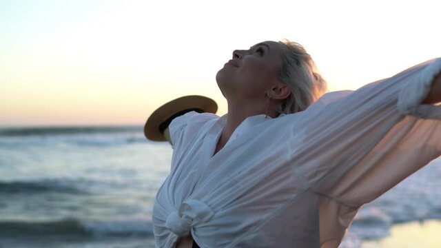 Carefree female in swimwear feeling freedom during sunbathing at coastline beach in Indonesia, Caucaisan plus size woman enjoying vacations journey for summer recreation
