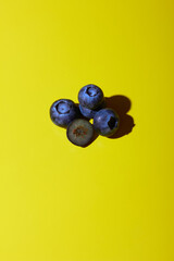 Blueberries on yellow background