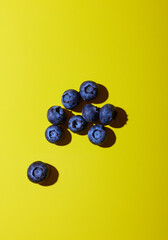 Blueberries on yellow background