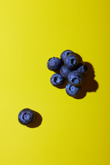 Blueberries on yellow background