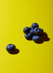 Blueberries on yellow background