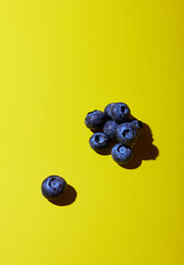 Blueberries on yellow background