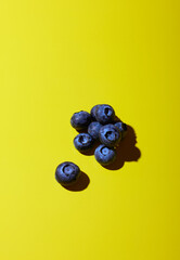 Blueberries on yellow background
