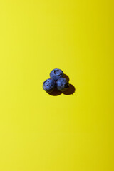 Blueberries on yellow background