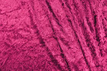 Dark pink panne velvet textile texture with folds