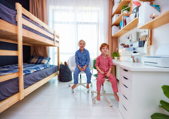 shared kids bedroom with bunk bed, big table and wall shelves, for two boys - obrazy, fototapety, plakaty