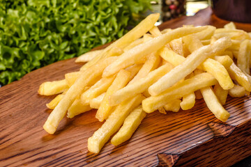 Fresh hot french fries with salt vegetables and spices