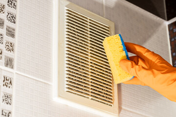 domestic dirty air ventilation grid cleaning. person dusting air duct