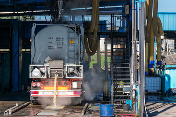 Tank truck inside a specific car wash for this type of vehicle.