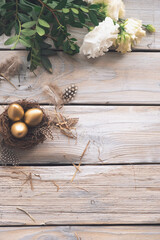 Easter background with Easter eggs and spring flowers. Top view with copy space