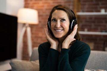 Smiling Woman Listening Music Using Headphones