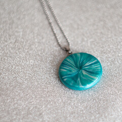 Fototapeta na wymiar handmade polymer clay necklace with turquoise pendant 