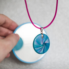 handmade polymer clay necklace with blue pendant 