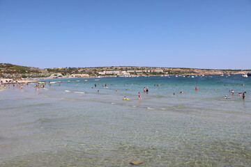 Fototapeta na wymiar Holiday at Mellieha Beach Bay at Mediterranean Sea, Malta