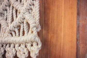 Wall panel in the style of Boho made of cotton threads in natural color using the macrame technique for home decor