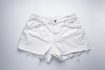 White denim shorts, front pockets, flat lay.