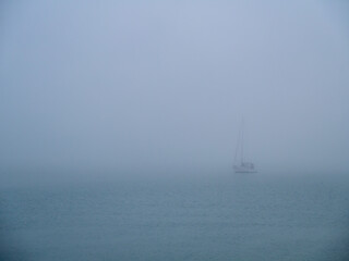 Boat in the fog in the bay of Cadiz capital, Andalusia. Spain. Europe.
