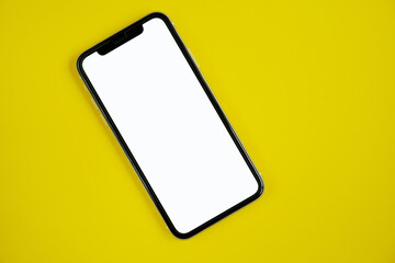 Mobile phone with white screen on yellow background