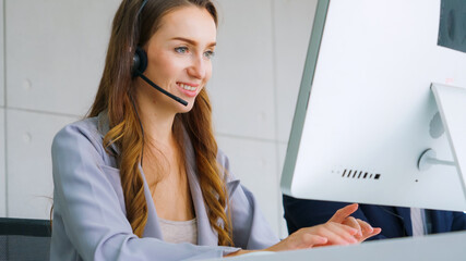 Business people wearing headset working in office to support remote customer or colleague. Call...