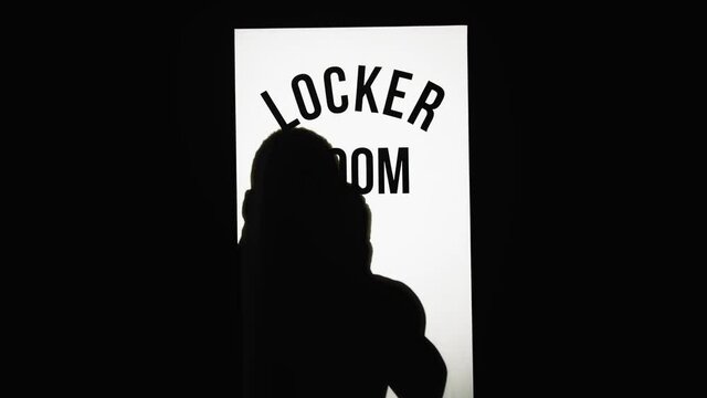 A Man Standing In Front Of The Door To The Changing Room In The Gym 