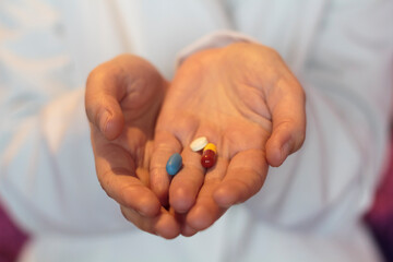 Doctor hand holding different medical pills