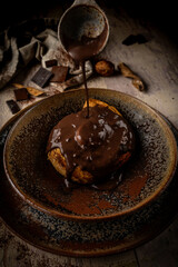 hot chocolate poured over a butter brioche inside a ceramic bowl