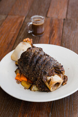 roasted whole beef shank with potato and carrots