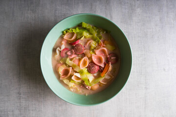 pasta with hotdog, chicken, carrots, onion and cabbage in milk soup also known as Sopas or Filipino macaroni soup; a comfort food in the Philippines