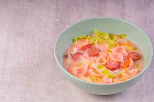 pasta with hotdog, chicken, carrots, onion and cabbage in milk soup also known as Sopas or Filipino macaroni soup; a comfort food in the Philippines