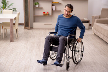 Young man in wheel-chair suffering at home