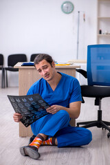 Young male doctor radiologist being unhappy after night shift