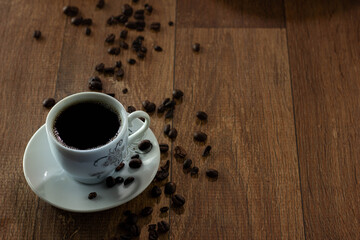 Closeup of Typical Brazilian Coffee Cup and Coffee Beans on a Wooden Table