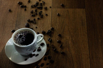 Closeup of Typical Brazilian Coffee Cup and Coffee Beans on a Wooden Table