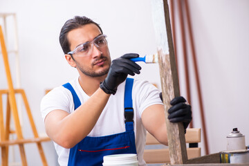 Young male contractor working in workshop