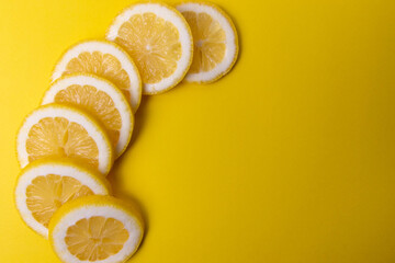 slices of lemon on yellow background 