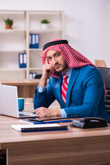 Young male arab employee working in office