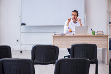 Young male doctor giving seminar in the classroom
